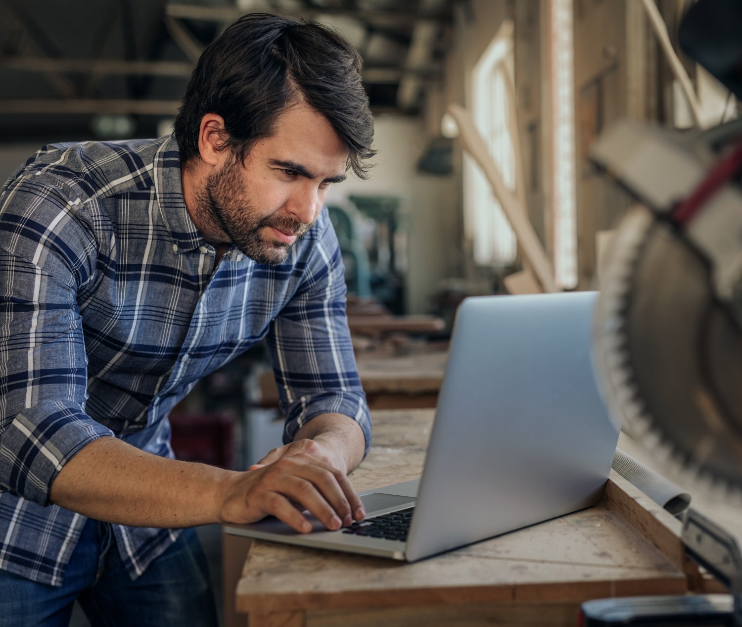 sema-aura-carpenter-working-laptop